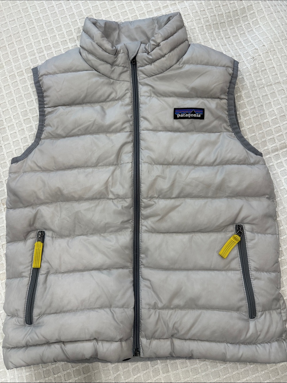 Patagonia Kids Light Gray Puffer Vest with Yellow Pull Tabs
